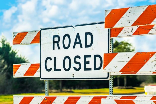 Road Closed sign and barricades on a street