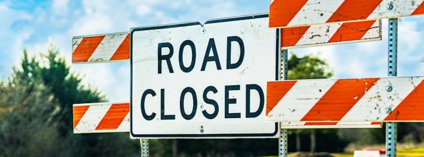 Road Closed sign and barricades on a street