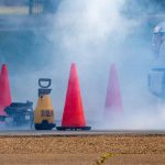 traffic cones around a cloud of smoke at a testing location