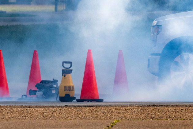 traffic cones around a cloud of smoke at a testing location