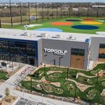 Aerial view of the TopGolf facility with minigolf course and colorful hitting range