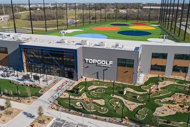 Aerial view of the TopGolf facility with minigolf course and colorful hitting range