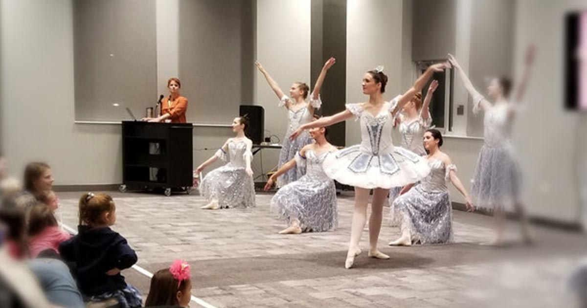 Ballet dancers performing for a group of children