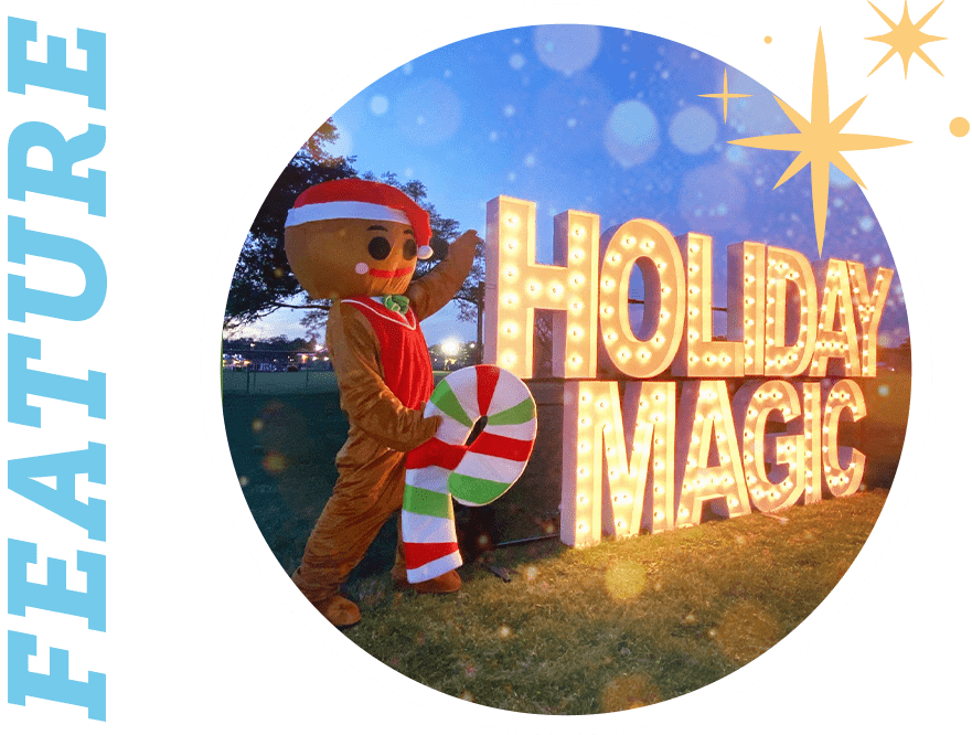 Feature: person dressed as a gingerbread man posing beside an illuminated sign with text "Holiday Magic"