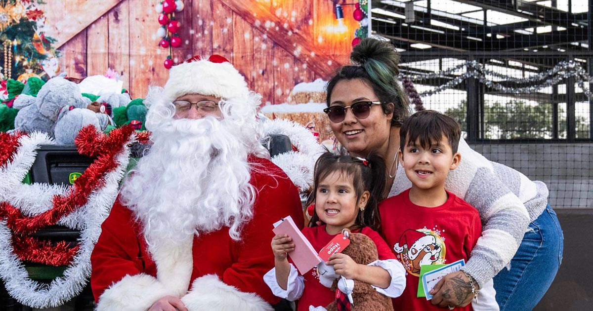 Family with children posing for a photo with Santa Claus