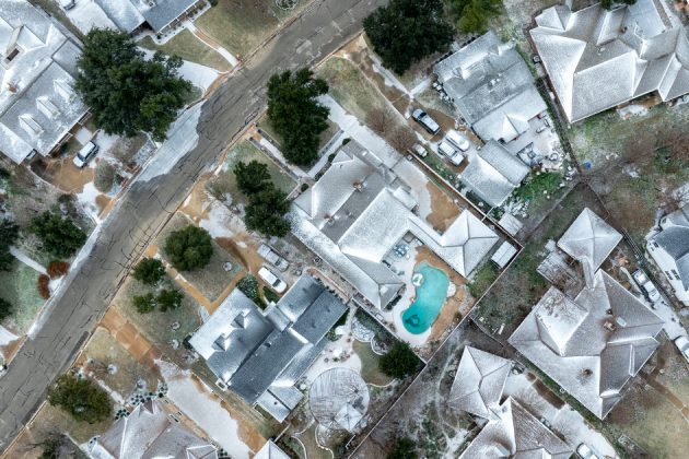 aerial photo of a Bryan neighborhood with roofs covered in snow and ice