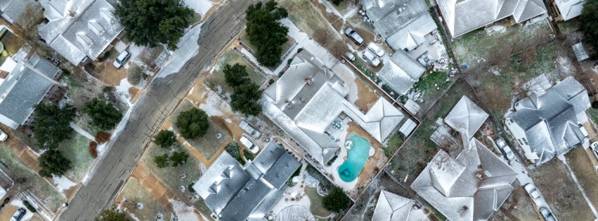 aerial photo of a Bryan neighborhood with roofs covered in snow and ice