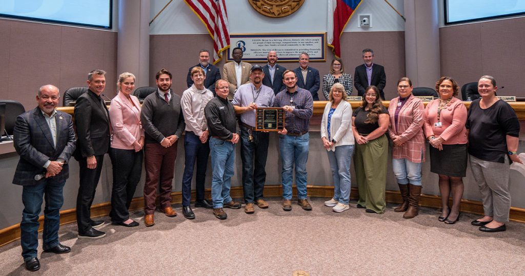 Development Services and Planning employees group photo showcasing the award trophy