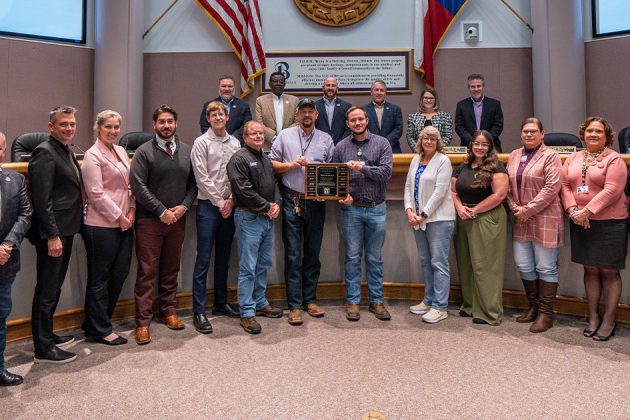 Development Services and Planning employees group photo showcasing the award trophy