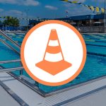 construction cone icon overlaying a photo of the Bryan Aquatic Center pool