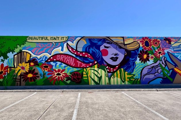 colorful mural on the side of a building featuring a cowgirl holding flowers in a pop art style