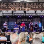 band performing on a stage with a crowd of people at the Big Barn Dance Music Festival