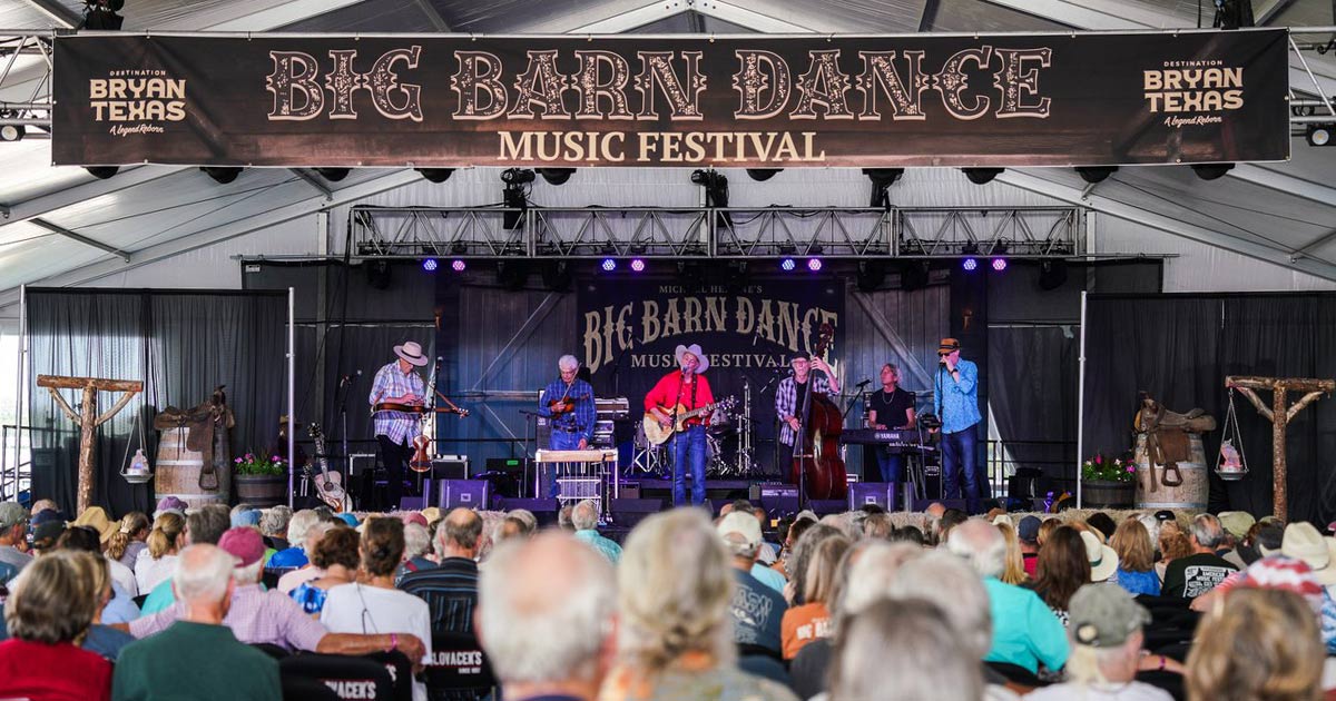 band performing on a stage with a crowd of people at the Big Barn Dance Music Festival