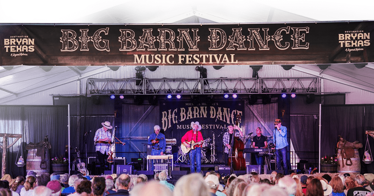 music venue filled with people watching a musical performance on stage at Big Barn Dance